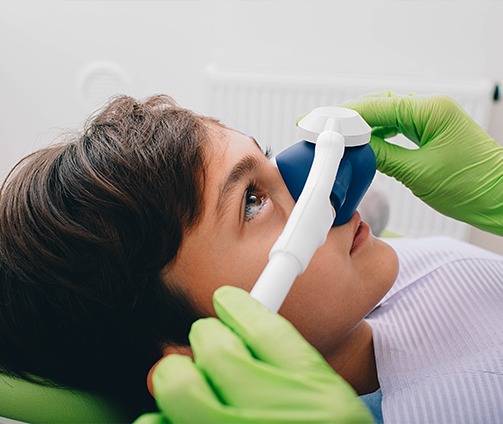 Young boy with a nitrous oxide mask over his nose