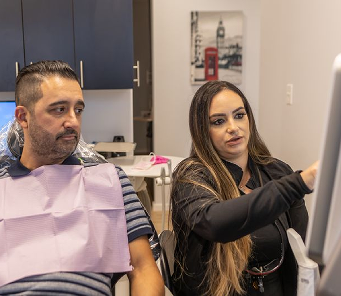 Dentist showing a patient a screen