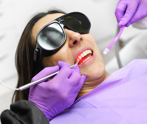 Dental patient having their gums treated with a laser