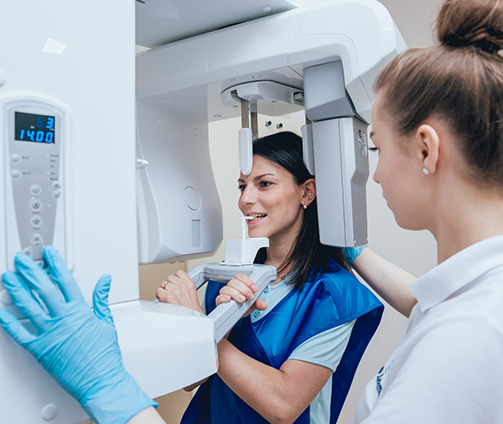 Dental patient getting a cone beam CT scan of her mouth and jaw