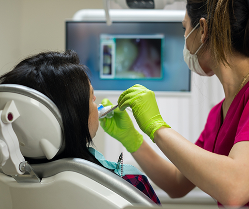 Dentist capturing close up photos of a patient's teeth