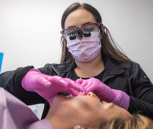Emergency dentist examining a patient's mouth