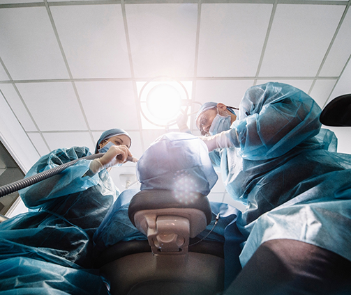 Dental professionals performing a procedure on a patient