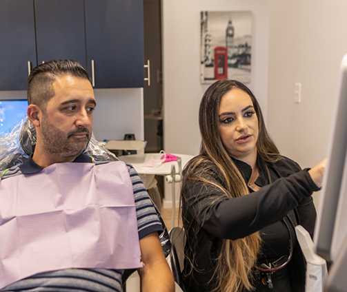 Dentist showing a patient a screen