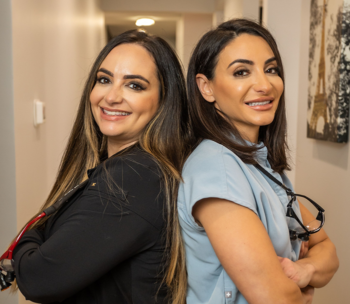 Doctor Sara and Doctor Roxana standing back to back with their arms crossed