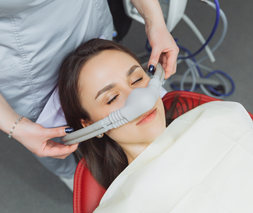 Dental patient with a nitrous oxide mask over her nose